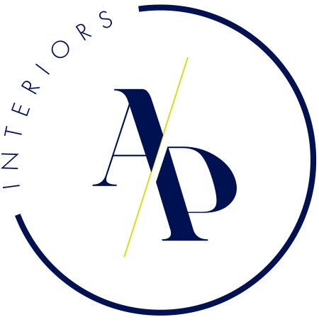 The AP Interiors monogram: navy A and P split by a chartreuse slash, set inside an open circle with the word INTERIORS curved around it